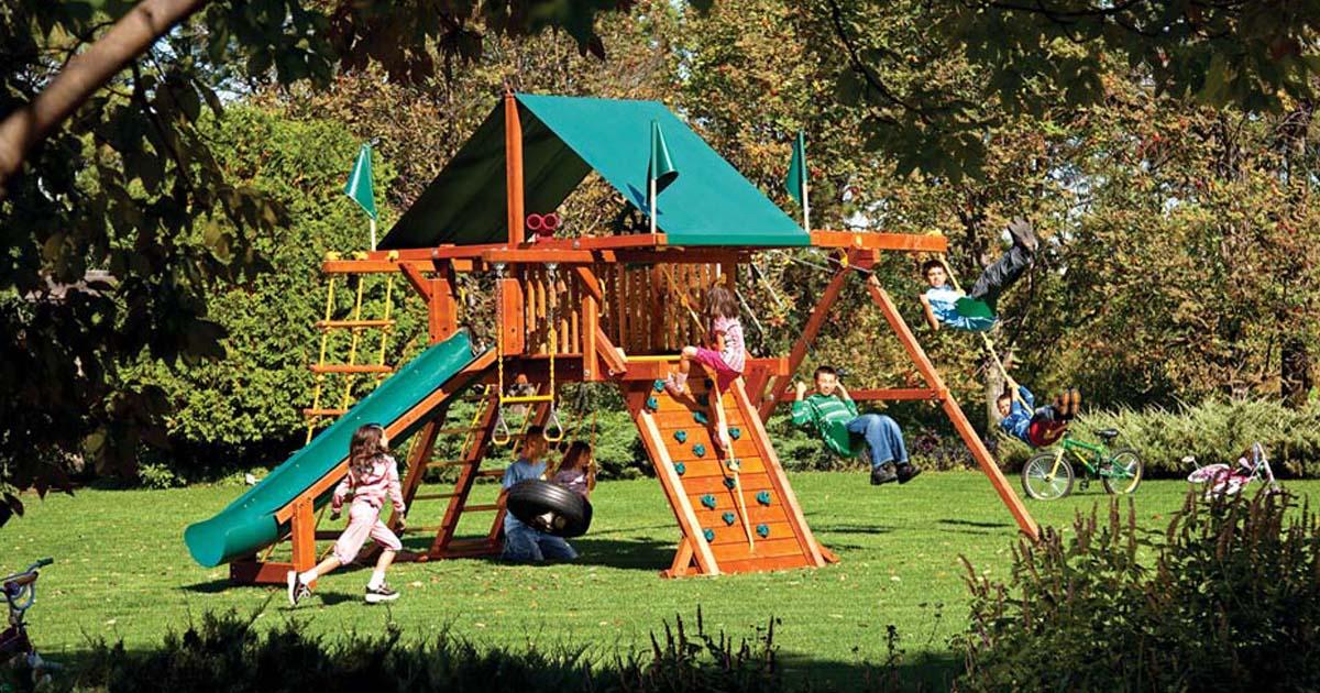 wooden climbing frame with rockwall & swings